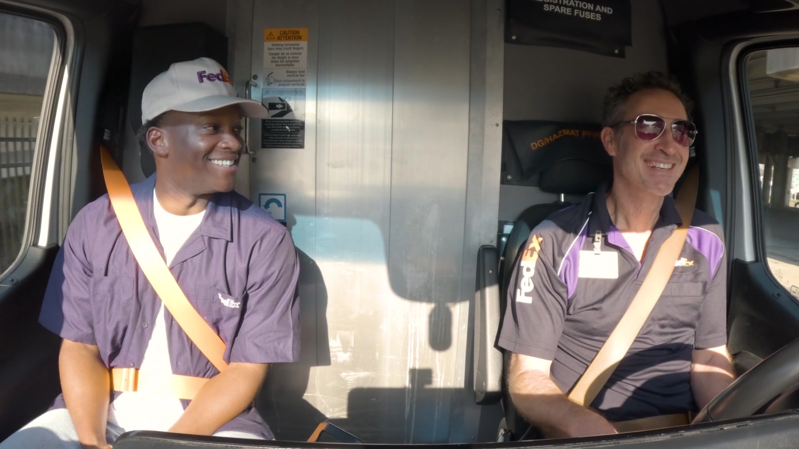 Titus Gardner riding alongside a FedEx courier in New Orleans
